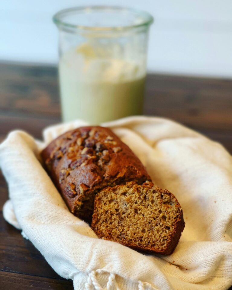 Close-up of freshly baked banana bread loaf on cloth, perfect for breakfast or snack.