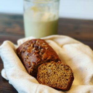 Close-up of freshly baked banana bread loaf on cloth, perfect for breakfast or snack.